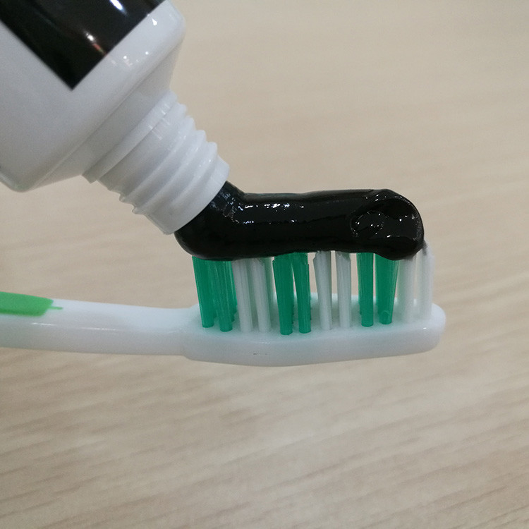 I denti di GMP che imbiancano lo spazzolino da denti del dentifricio in pasta hanno messo gli estratti di semi di erbe organici del cumino del nero di Miswak